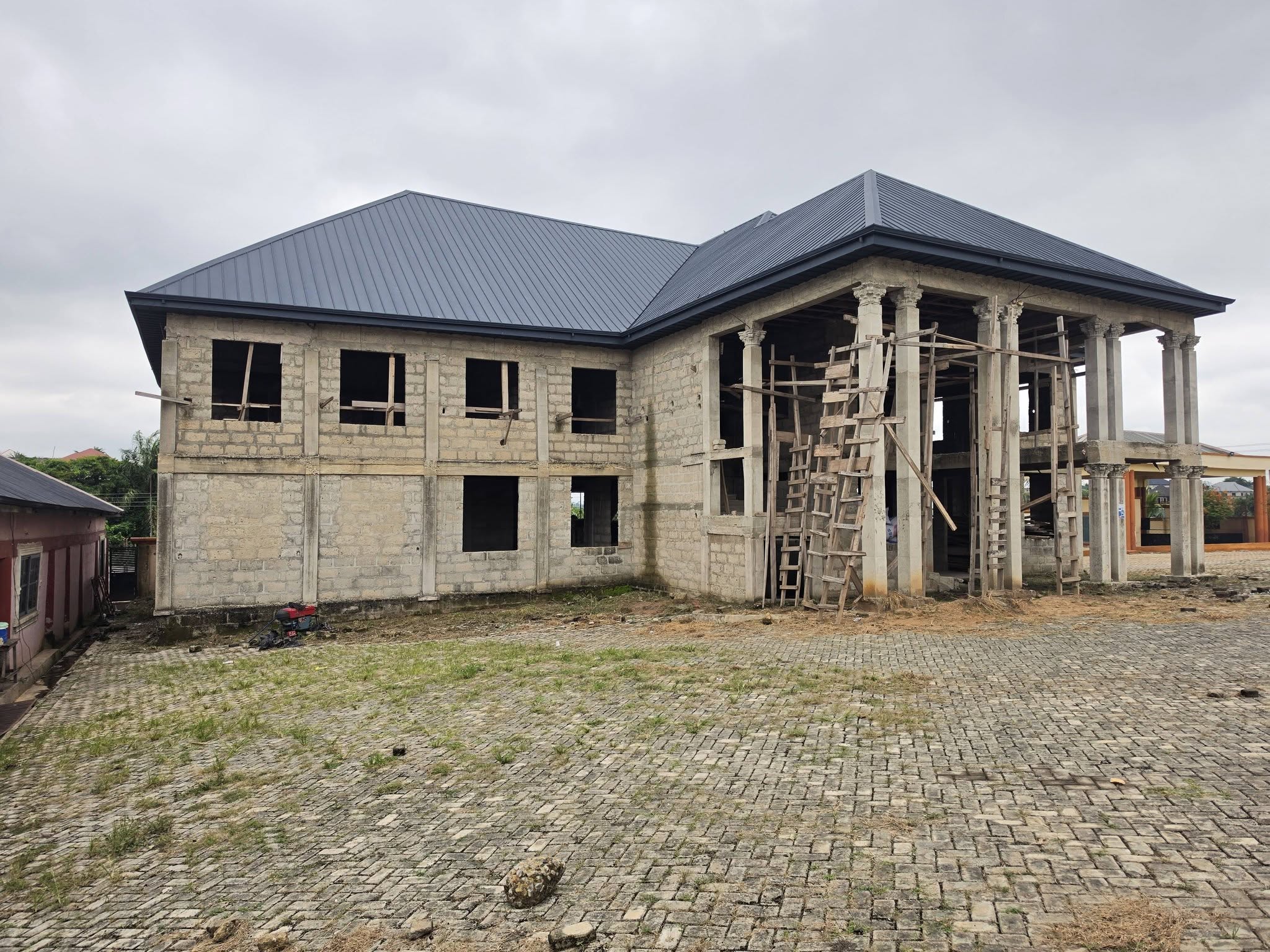 Before renovation: Raw masonry and structural framing stage in Ghana